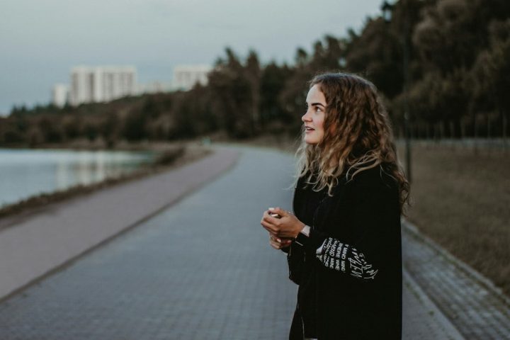 woman standing near body of water