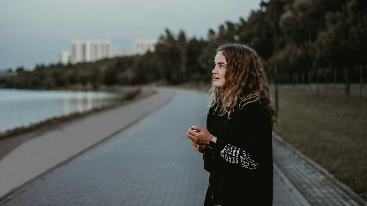 woman standing near body of water